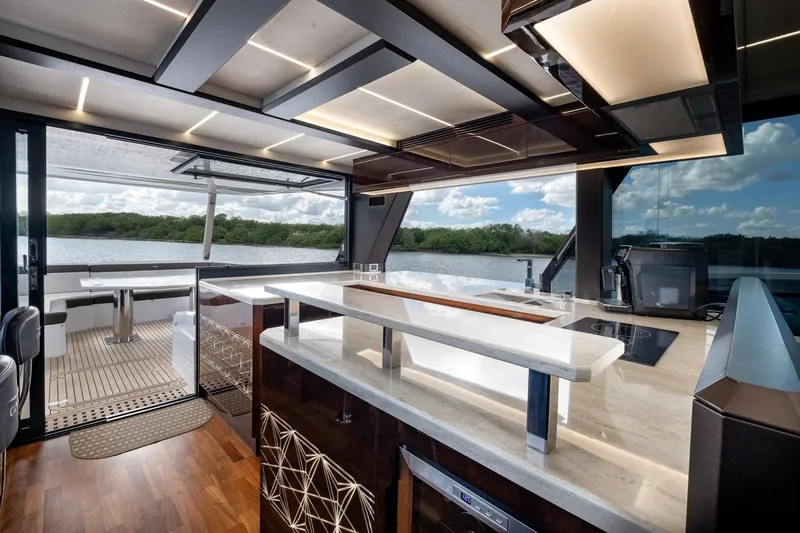 Slide: The Image of Luxurious interior of 2020 Galeon 640 Fly yacht with modern kitchen and scenic water view. - 22