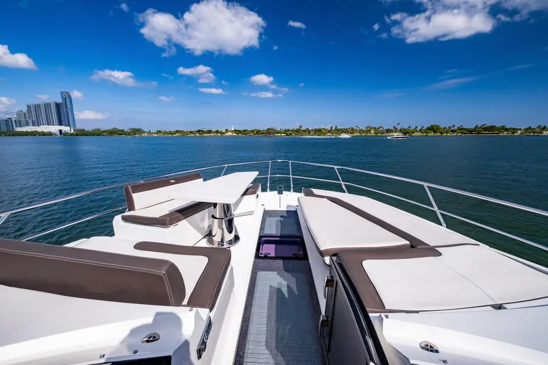 Slide: The Image of Luxurious 2020 Galeon 640 Fly yacht deck with seating, overlooking serene water and cityscape. - 29