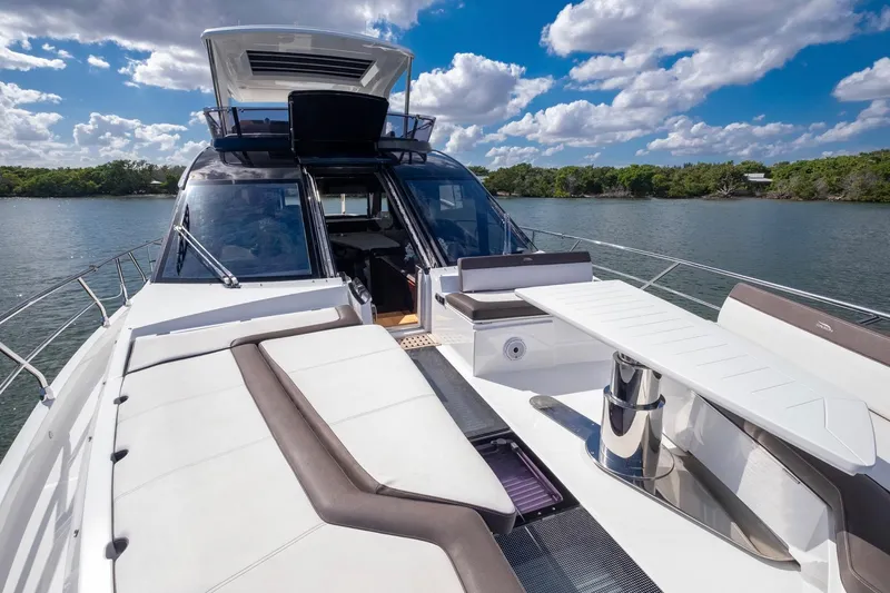 Slide: The Image of Luxurious 2020 Galeon 640 Fly yacht with spacious deck and seating, under a clear blue sky. - 30