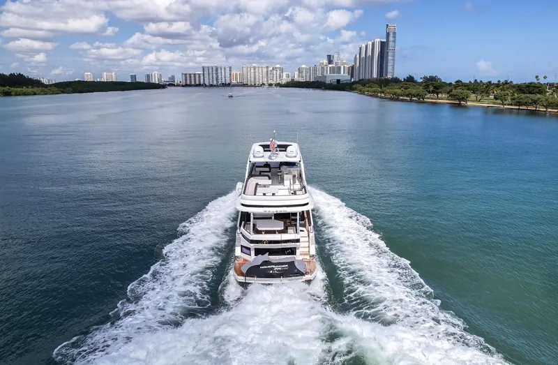 Slide: The Image of Galeon 640 Fly 2020 yacht cruising on a scenic waterway with city skyline. - 4
