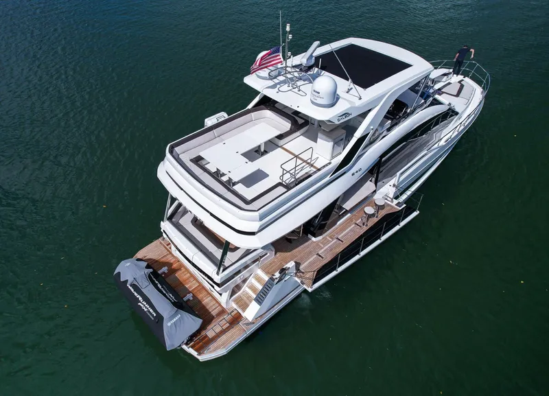 Slide: The Image of 2020 Galeon 640 Fly yacht on water, aerial view, showcasing sleek design and spacious deck. - 9