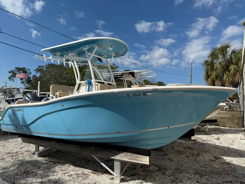 The Image of 2018 Sea Fox 226 Commander boat in light blue, parked on a gravel lot under a clear sky. - 0