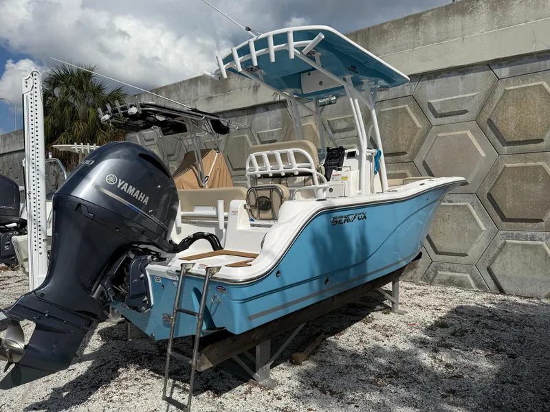 Slide: The Image of 2018 Sea Fox 226 Commander boat with Yamaha engine, parked on gravel. - 1