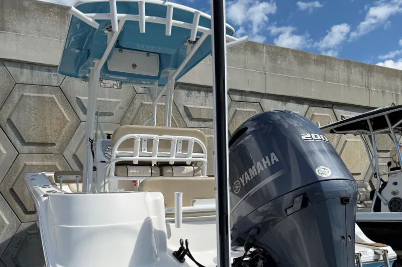 Slide: The Image of 2018 Sea Fox 226 Commander boat with Yamaha 200 engine, docked under blue sky. - 4