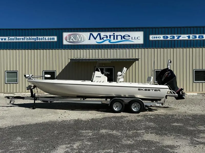 Slide: The Image of 2024 Skeeter SX230 boat on trailer outside L&M Marine LLC building. - 0