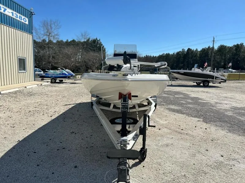 Slide: The Image of 2024 Skeeter SX230 boat on trailer in outdoor lot, clear sky background. - 1