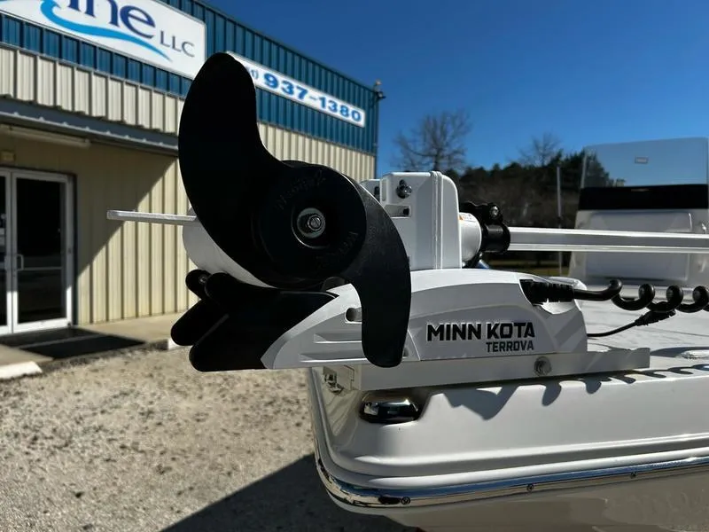 Slide: The Image of 2024 Skeeter SX230 boat with Minn Kota Terrova motor, parked outside a building. - 10