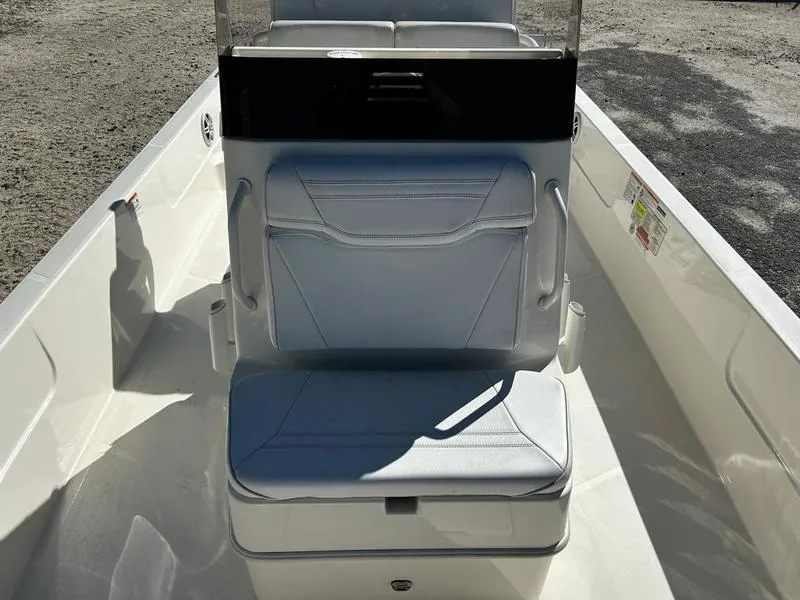 Slide: The Image of 2024 Skeeter SX230 boat interior with cushioned seating and console. - 12