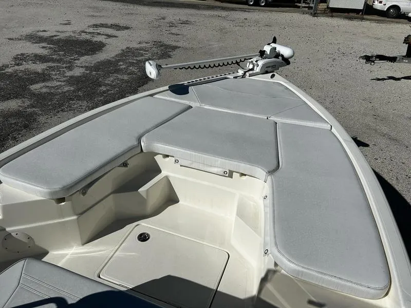 Slide: The Image of 2024 Skeeter SX230 boat deck with cushioned seating and trolling motor. - 14