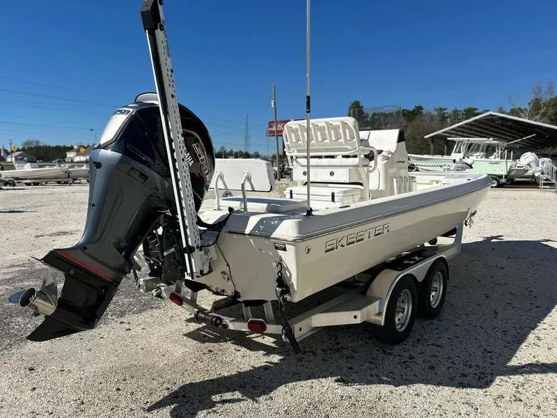 Slide: The Image of 2024 Skeeter SX230 boat on trailer, featuring powerful outboard motor. - 7