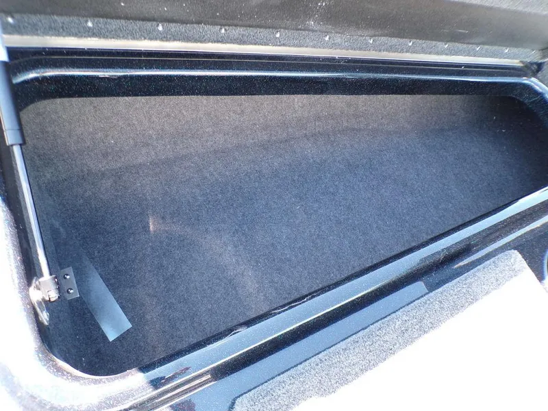 Slide: The Image of 2024 Skeeter ZX150 storage compartment with carpeted interior. - 18