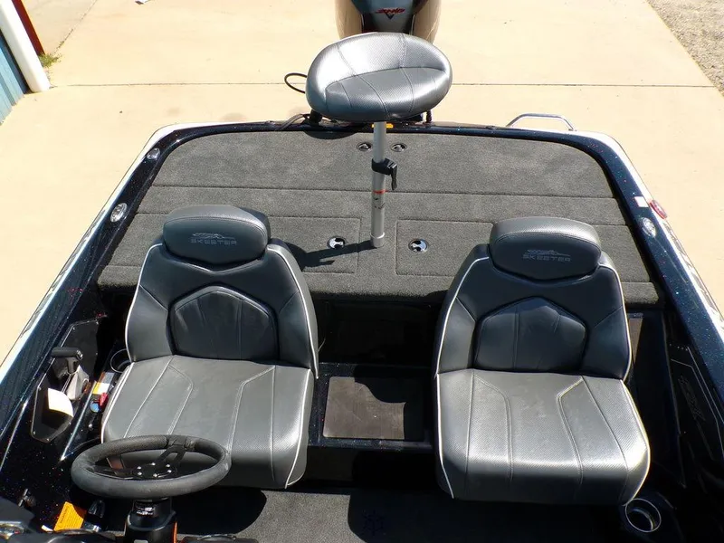 Slide: The Image of 2024 Skeeter ZX150 boat interior with dual seats and steering wheel. - 24