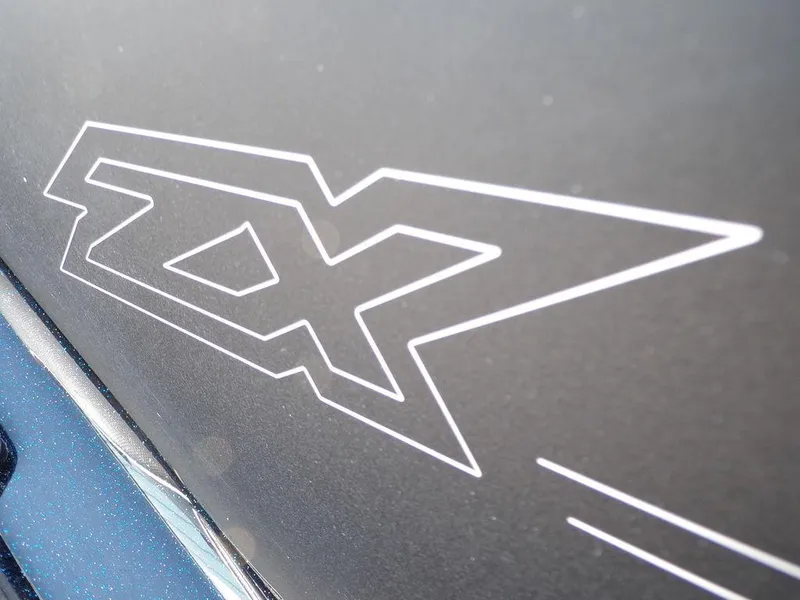 Slide: The Image of 2024 Skeeter ZX150 logo on sleek black surface. - 25