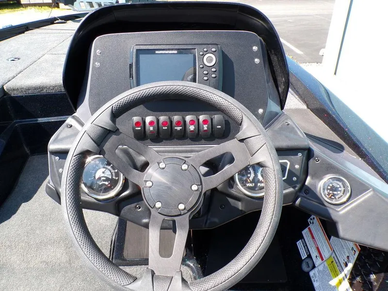 Slide: The Image of 2024 Skeeter ZX150 boat dashboard with steering wheel and control panel. - 26