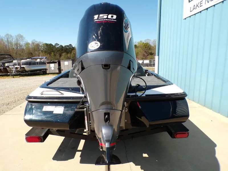 Slide: The Image of 2024 Skeeter ZX150 boat with powerful outboard motor, parked outdoors. - 4