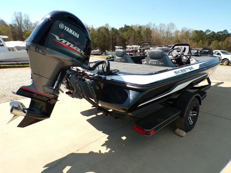 Slide: The Image of 2024 Skeeter ZX150 boat with Yamaha engine, parked outdoors on a sunny day. - 5