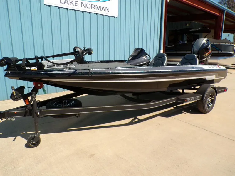 Slide: The Image of 2024 Skeeter ZX150 boat on trailer, parked outside Lake Norman building. - 7