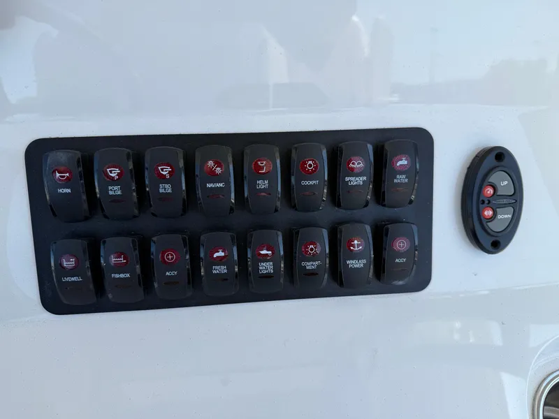 Slide: The Image of Control panel with multiple switches on a 2016 Jupiter 26 boat. - 15