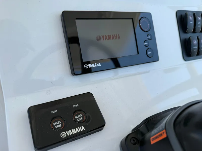 Slide: The Image of Control panel of a 2016 Jupiter 26 boat featuring Yamaha electronics. - 16