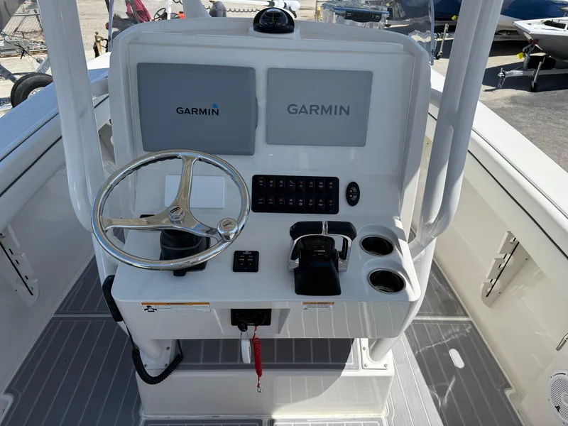 Slide: The Image of 2016 Jupiter 26 boat console with Garmin displays and steering wheel. - 20
