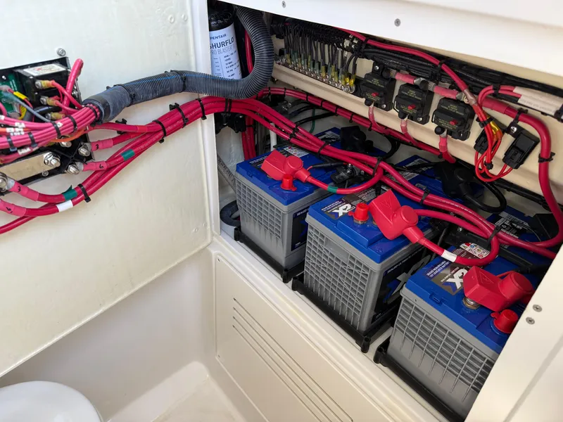 Slide: The Image of Battery compartment with wiring in a 2016 Jupiter 26 boat. - 25