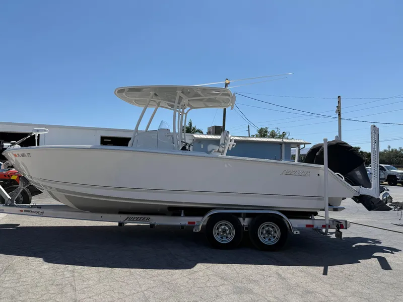 Slide: The Image of 2016 Jupiter 26 boat on trailer under clear blue sky. - 29