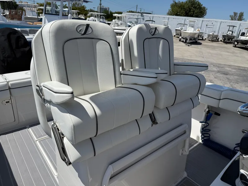 Slide: The Image of Twin outboard motors on a 2016 Jupiter 26 boat, parked on a sunny day. - 3