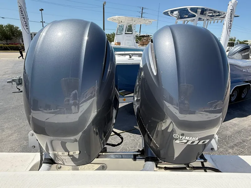 Slide: The Image of Open storage compartment on a 2016 Jupiter 26 boat deck, containing black bags. - 4