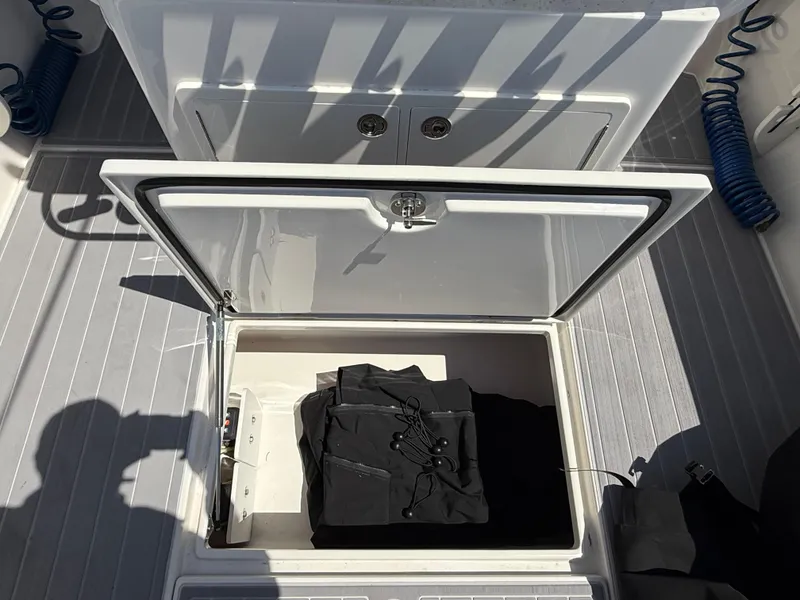 Slide: The Image of Storage compartment on a 2016 Jupiter 26 boat with a mounted radio. - 9