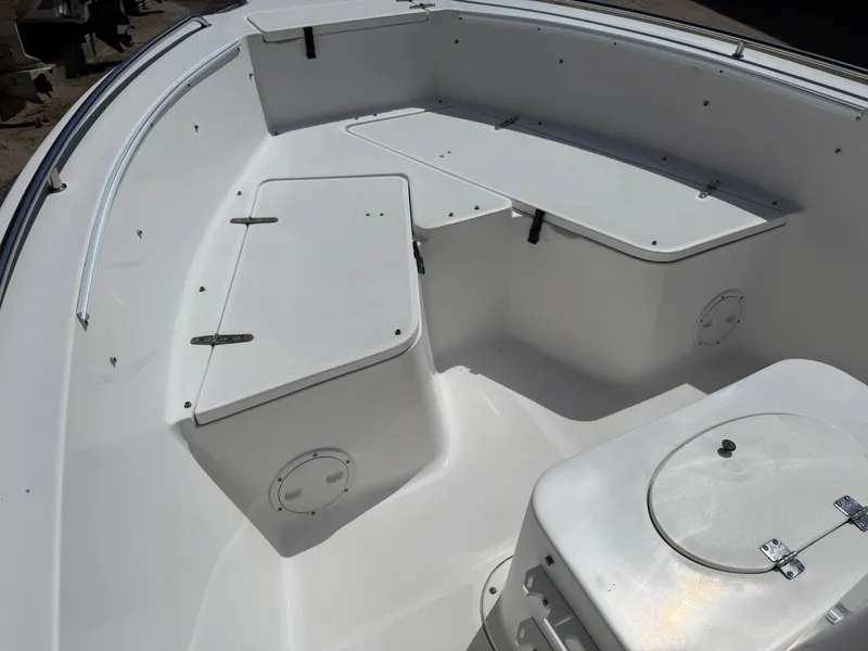 Slide: The Image of 2007 Sea Hunt 202 TRITON boat interior with white seating and storage compartments. - 12