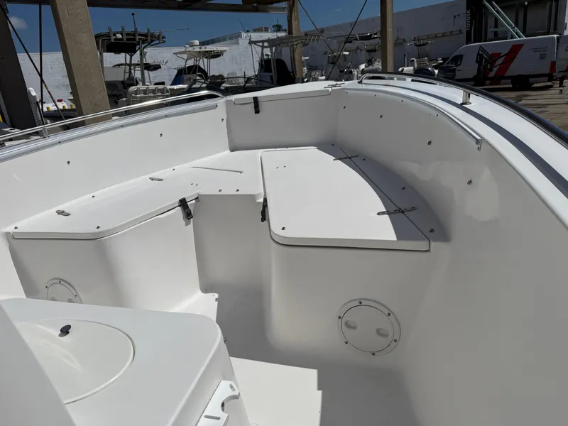 Slide: The Image of 2007 Sea Hunt 202 TRITON boat interior with white seating and storage compartments. - 8