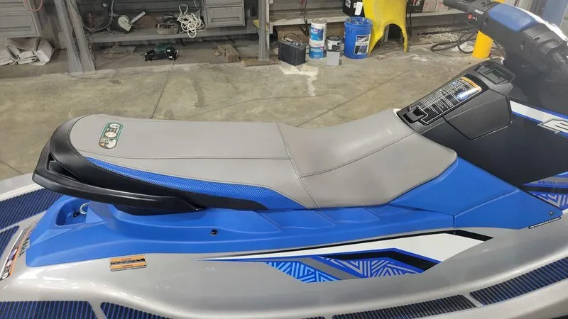 Slide: The Image of 2020 Yamaha WaveRunner EX Deluxe in a garage, featuring a sleek blue and gray design. - 7