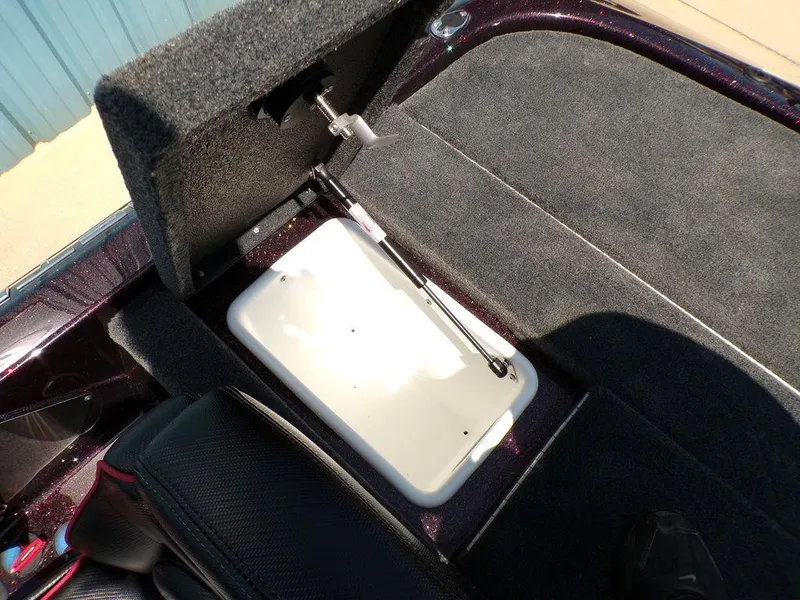 Slide: The Image of 2024 Skeeter ZX150 boat storage compartment with hydraulic lift and carpeted interior. - 1