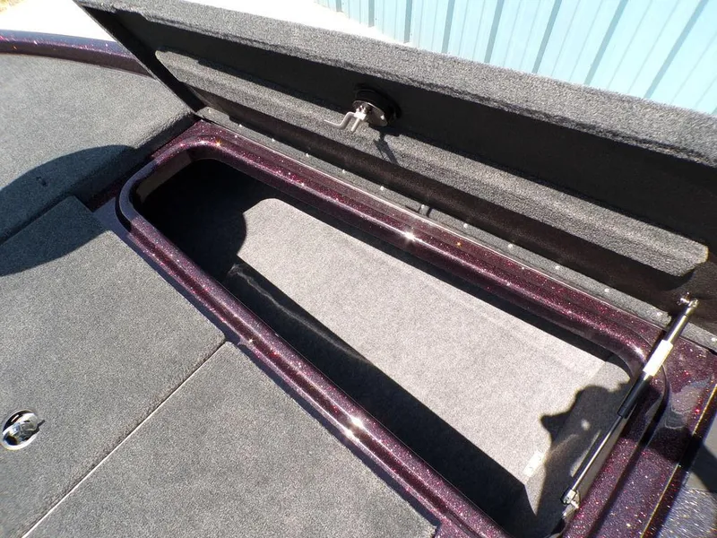Slide: The Image of 2024 Skeeter ZX150 boat storage compartment with open lid, showcasing spacious interior. - 10