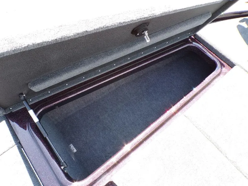 Slide: The Image of 2024 Skeeter ZX150 storage compartment with open lid, showcasing spacious interior. - 11