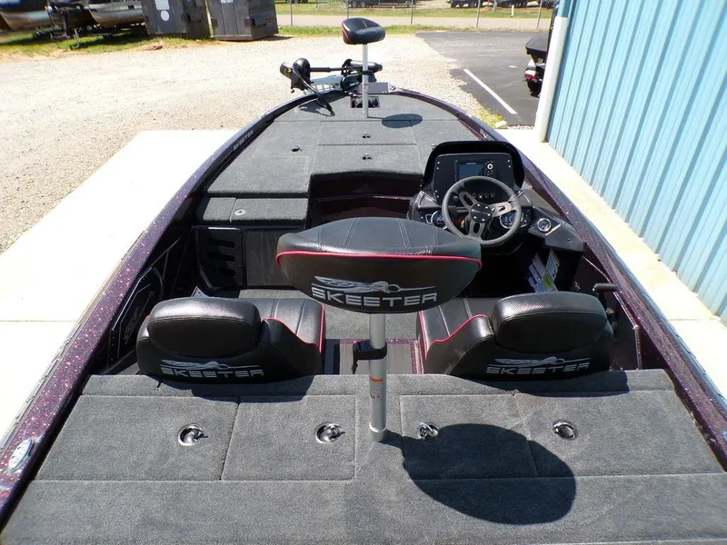 Slide: The Image of 2024 Skeeter ZX150 boat interior with steering wheel and seating, showcasing spacious design. - 12