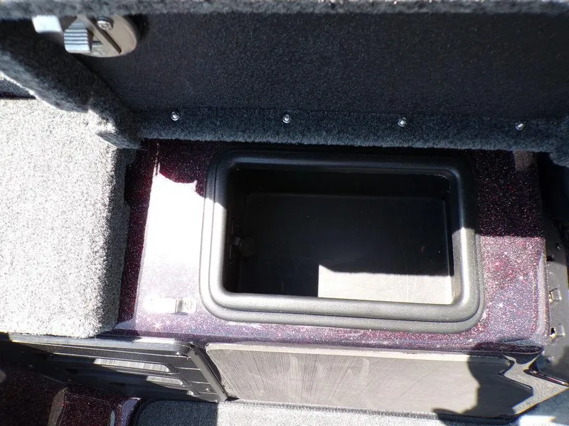 Slide: The Image of 2024 Skeeter ZX150 boat storage compartment with open lid, showing interior space. - 7