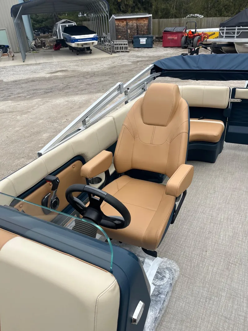 Slide: The Image of 2025 Avalon Aura 21 boat interior with tan seating and steering wheel. - 5