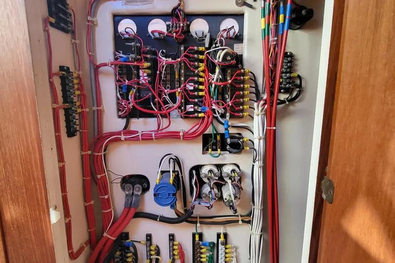 Slide: The Image of Electrical panel with organized wiring in a 1992 Corsair 42 boat. - 10