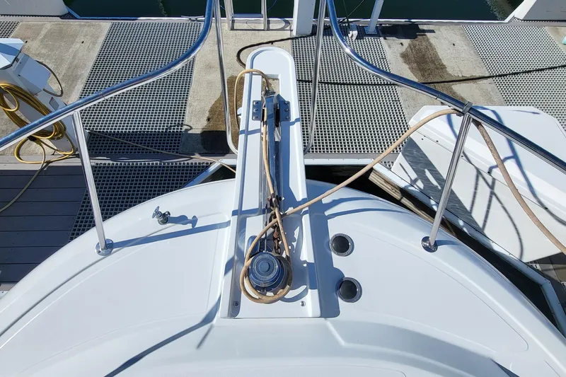 Slide: The Image of Bow of 1992 Corsair 42 yacht docked, featuring deck equipment and railings. - 2
