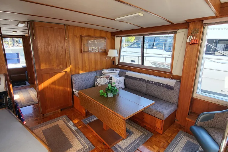 Slide: The Image of Cozy interior of 1992 Corsair 42 yacht with wooden decor and seating area. - 26