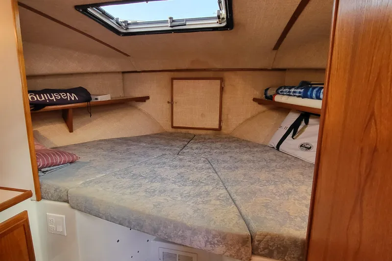 Slide: The Image of Cozy cabin interior of 1992 Corsair 42 boat with skylight and storage shelves. - 27