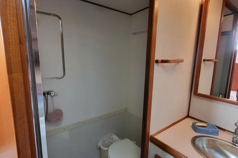 Slide: The Image of Bathroom interior of a 1992 Corsair 42 yacht, featuring a sink and toilet. - 29