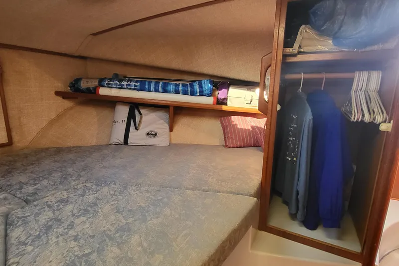 Slide: The Image of Cozy cabin interior of 1992 Corsair 42 sailboat with bed, storage, and hanging clothes. - 30