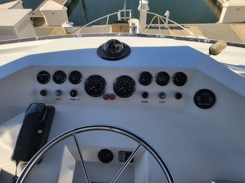 Slide: The Image of Control panel of a 1992 Corsair 42 boat with gauges and steering wheel. - 6