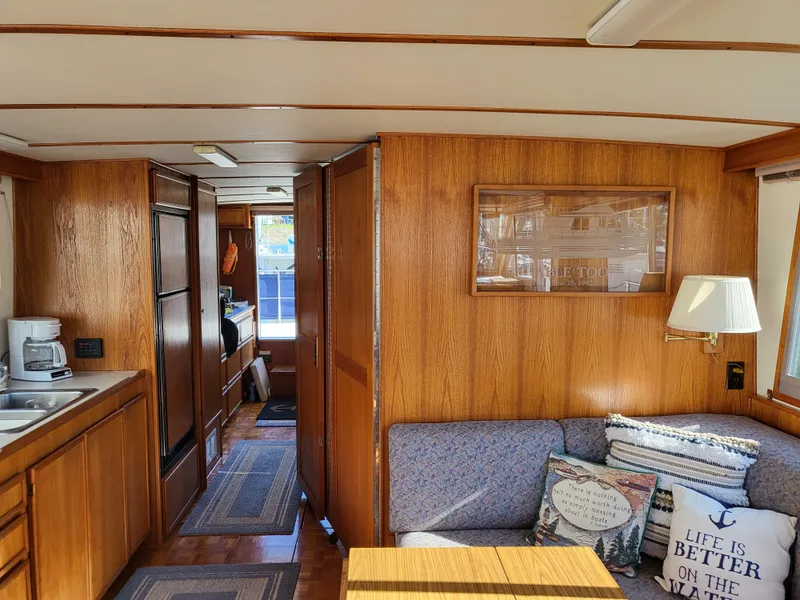 Slide: The Image of Interior of a 1992 Corsair 42 boat with wooden cabinetry and kitchen amenities. - 16