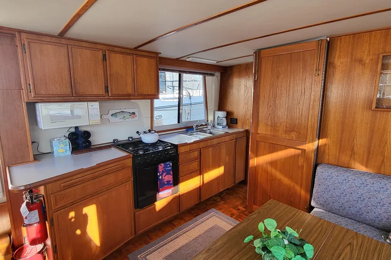Slide: The Image of Interior of 1992 Corsair 42 boat kitchen with wooden cabinets and appliances. - 17