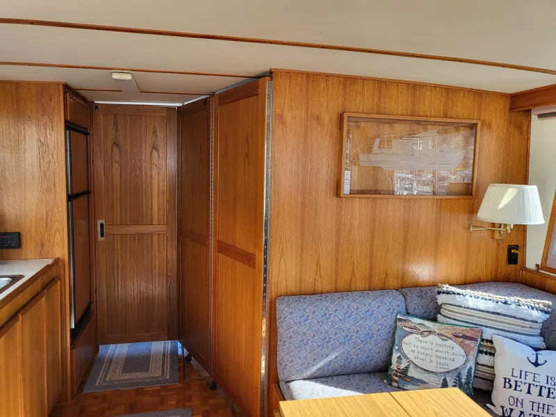 Slide: The Image of Interior of 1992 Corsair 42 boat with wooden paneling and kitchenette. - 18
