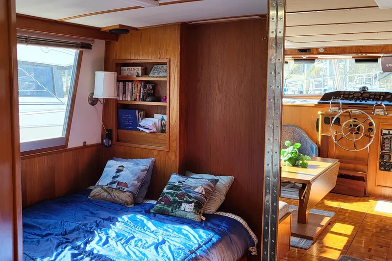 Slide: The Image of Interior of a 1992 Corsair 42 boat with cozy wooden decor and seating area. - 21