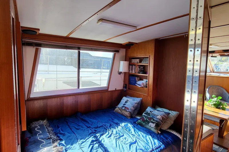 Slide: The Image of Cozy 1992 Corsair 42 boat kitchen with wooden cabinets and dining area. - 22
